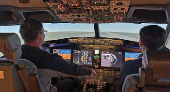 The author takes simulator instruction from a former Air Force pilot.