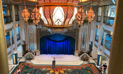 The atrium on the Disney Treasure features ornate lighting inspired by the movie "Aladdin."