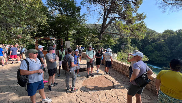 Guests listen to a guide during an excursion to Krka National Park in Croatia.