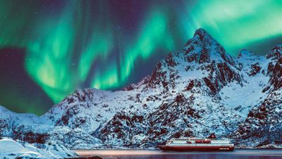 Hurtigruten's Richard With under the Northern Lights in Arctic Norway.