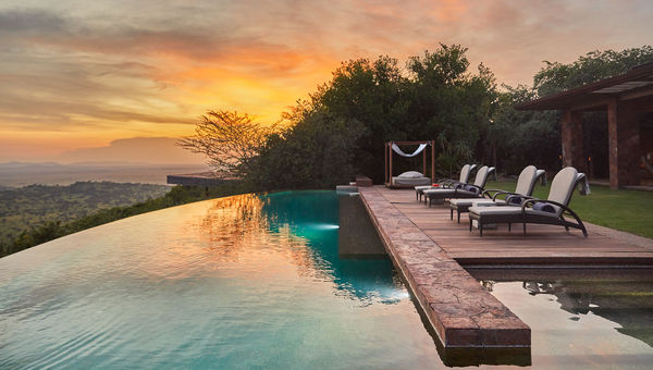 The infinity pool at Singita Kilima offers panoramic views over the Serengeti plains and wildlife migration routes.